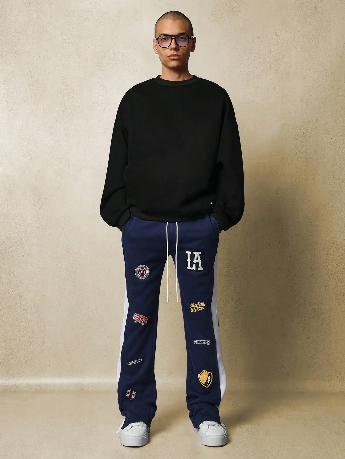 Flare Fit Contrast Panel Split Hem Sweatpants With All Over Embroidered Badge