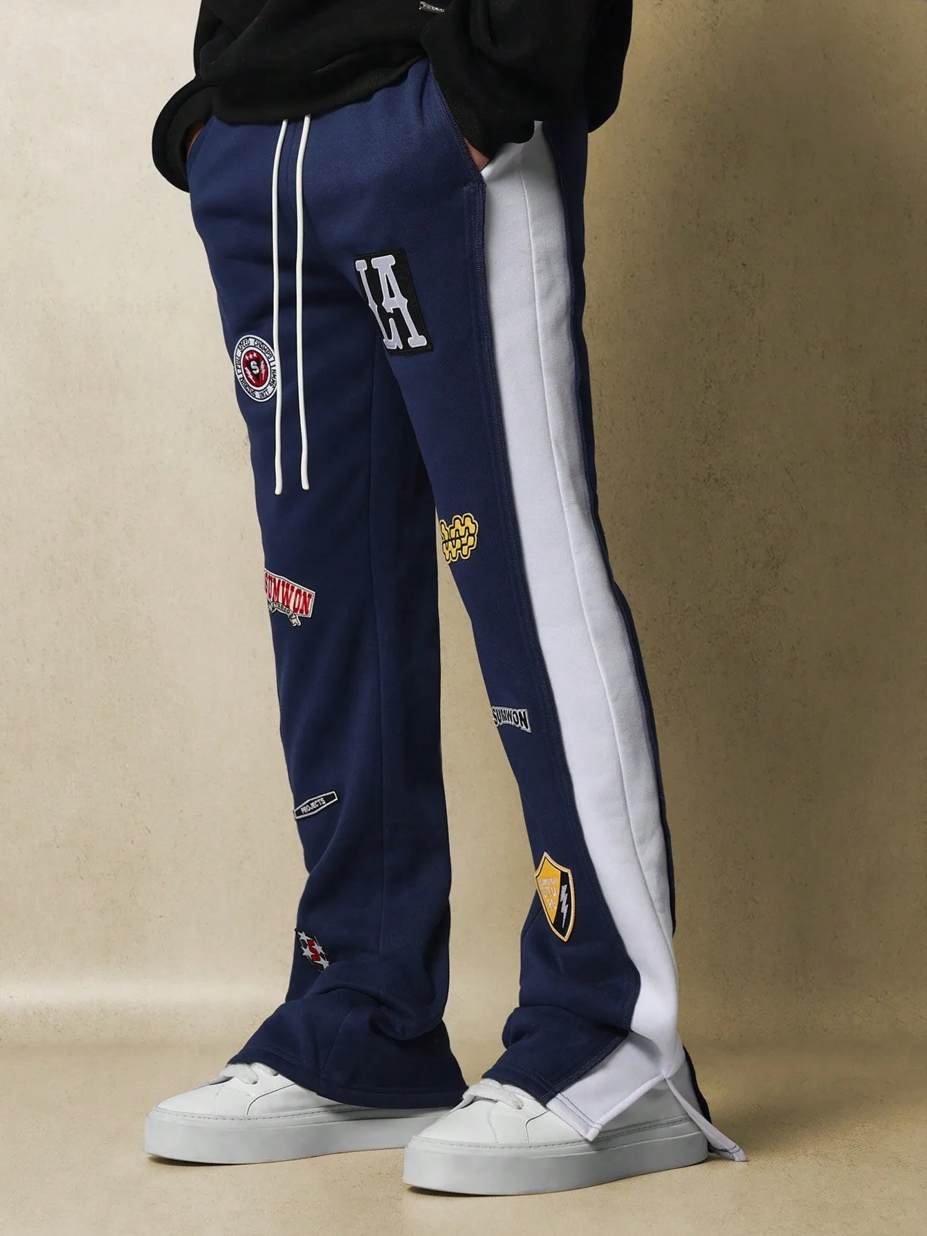 Flare Fit Contrast Panel Split Hem Sweatpants With All Over Embroidered Badge