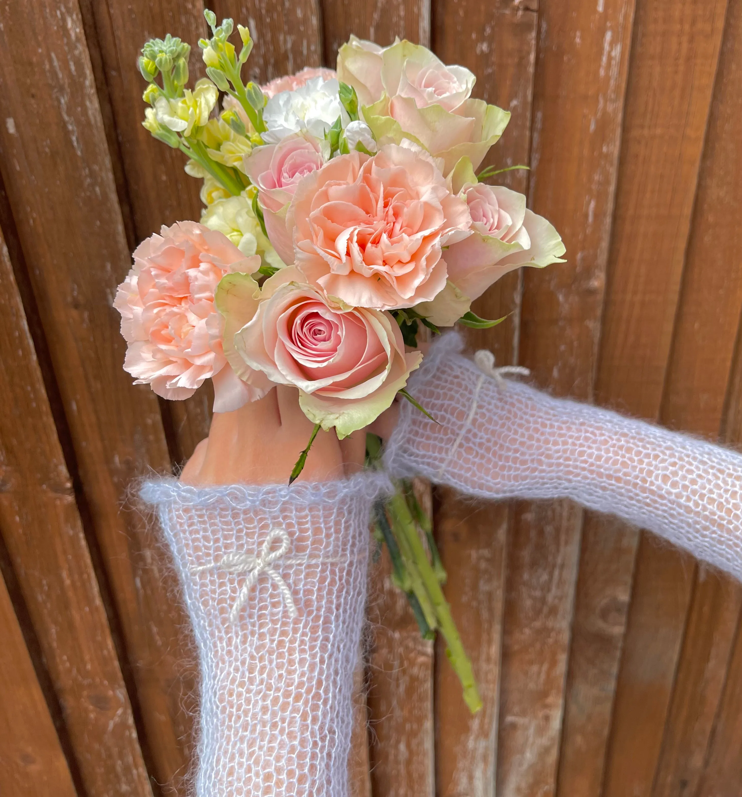 Handmade knitted mohair hand warmers in baby blue with beige bow